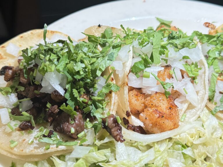 One beef and one chicken soft tacos with cilantro and onions on kids menu