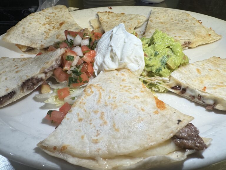 Delicious quesadillas filled with cheese and beef served with salsa, sour cream, and guacamole at La Tapatia