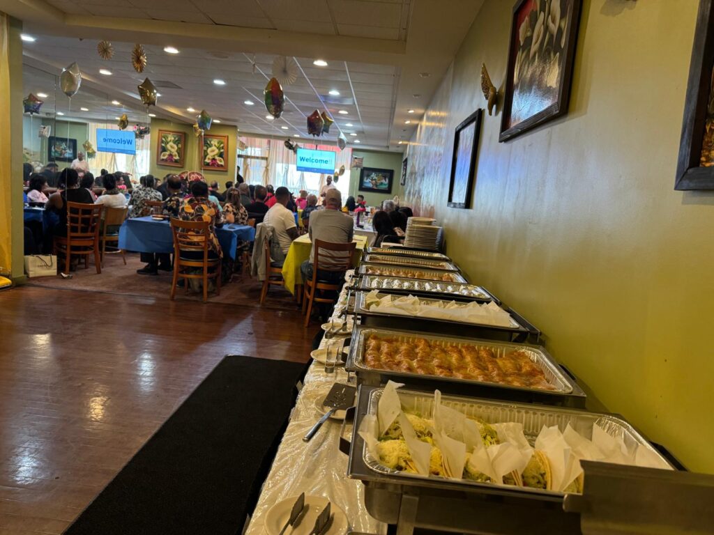 Guests sitting in front of food trays at La Tapatia’s banquet hall arranged for an event