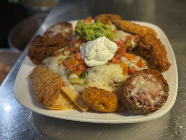 Fiesta Combo with nachos, chicken strips, buffalo wings, sour cream, and guacamole at La Tapatia